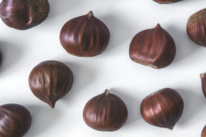 Photo by Tijana Drndarski 2 brown round fruit on white textile