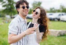 만성피로, 일상 속 작은 변화로 극복한다 Young couple laughing outdoors on a sunny day.