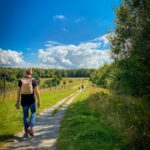 “직장인 건강, 작은 변화로 지키는 일상 루틴이 대세” man in brown t-shirt and blue denim shorts walking on pathway between green grass field